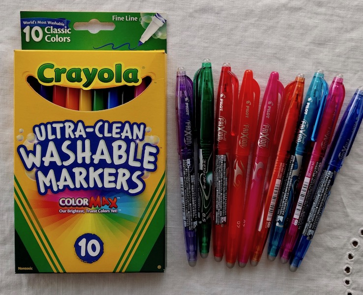 Packet of Crayola Ultra Clean Washable Markers and several Pilot Frixion pens.